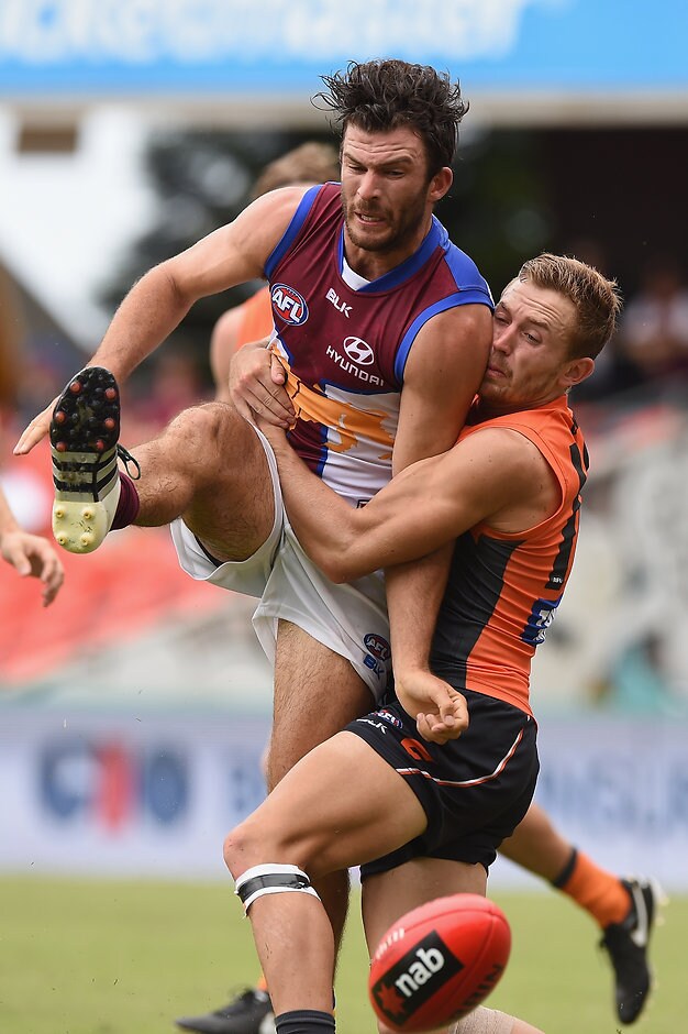 AFL 2016 NAB Challenge - Brisbane v GWS Rohan Bewick rides a big tackle from Devon Smith at Metricon Stadium - ${keywords}